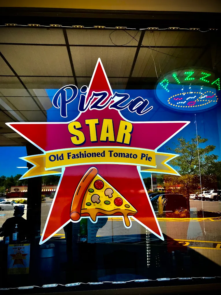 Pizza Star logo in the storefront window